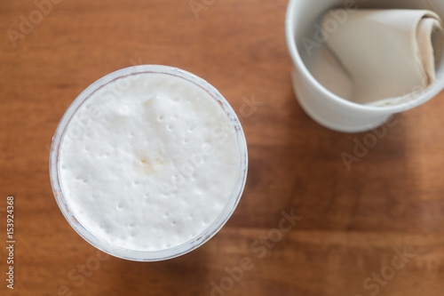 Milk froth in a cup on wood table