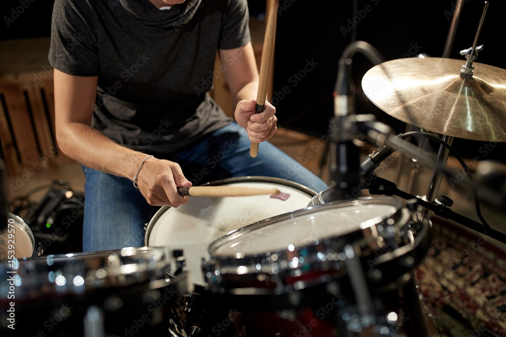 male musician playing drums and cymbals at concert male musician playing drums and cymbals at concert