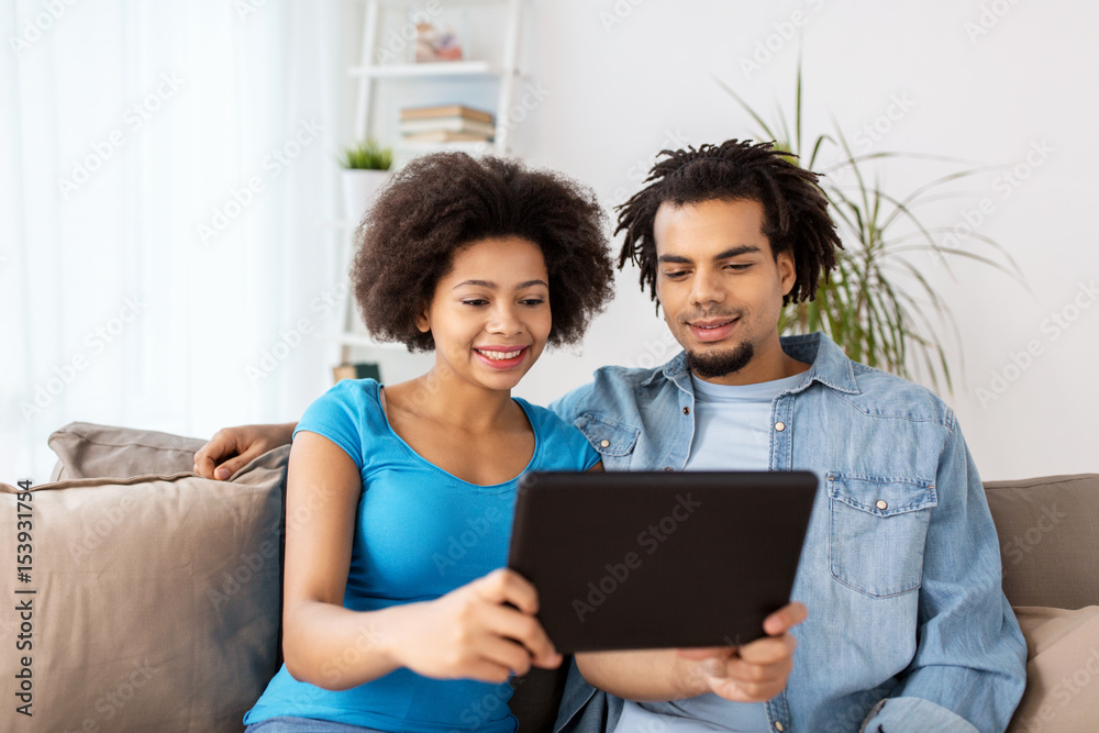 smiling happy couple with tablet pc at home smiling happy couple with tablet pc at home