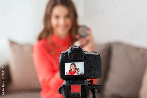 woman with bronzer and camera recording video
