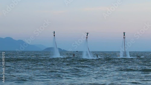 Silhouette of a fly board rider, Three people, show, world cup, synchronous performance