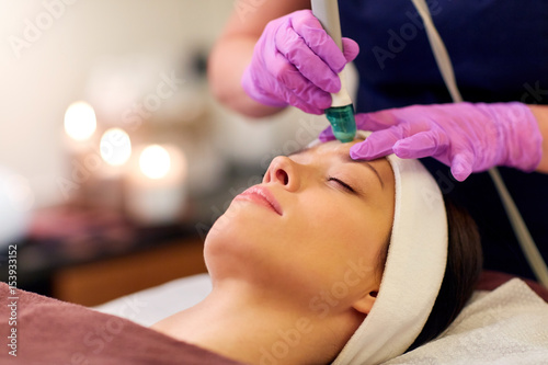 woman having microdermabrasion facial treatment photo