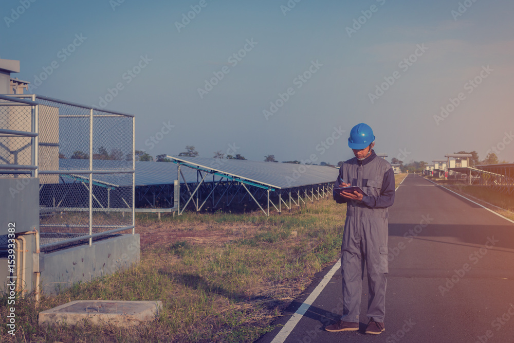 electrician working on checking status inverter and maintenance equipment at green energy solar power plant