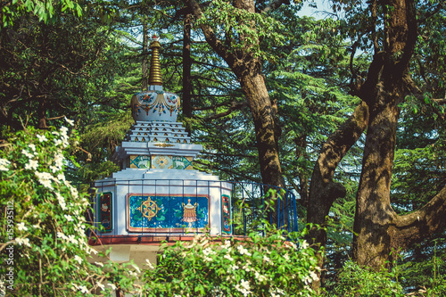 Buddhist stupa against the background of green trees