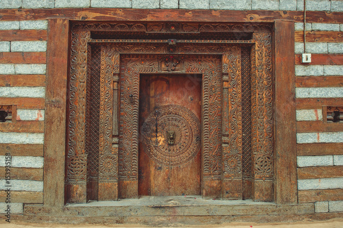 Old wooden door with ornaments in the village of Vashisht