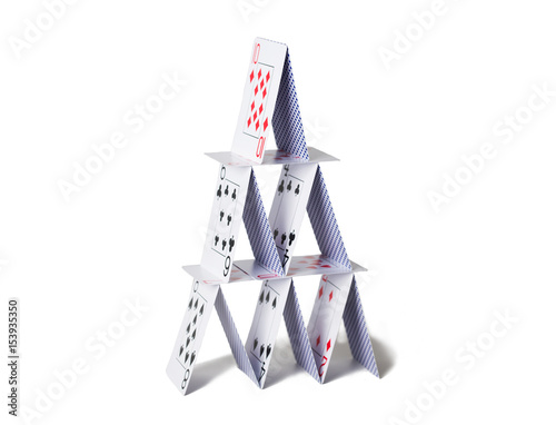 house of playing cards over white background