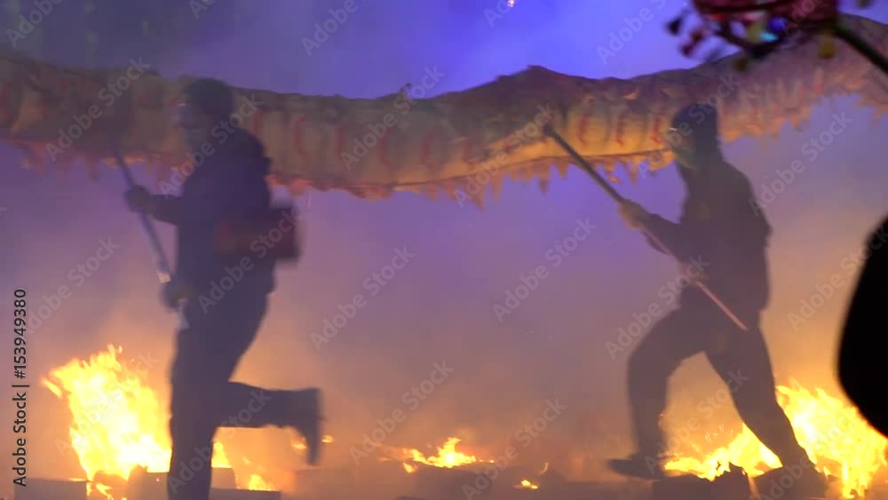 Slow motion Festival Taiwan of Hakka Dragon Bombing Dance. People dancing dragon up, down, side-to-side throw fireworks and firecrackers. Explosions and smoke-Dan