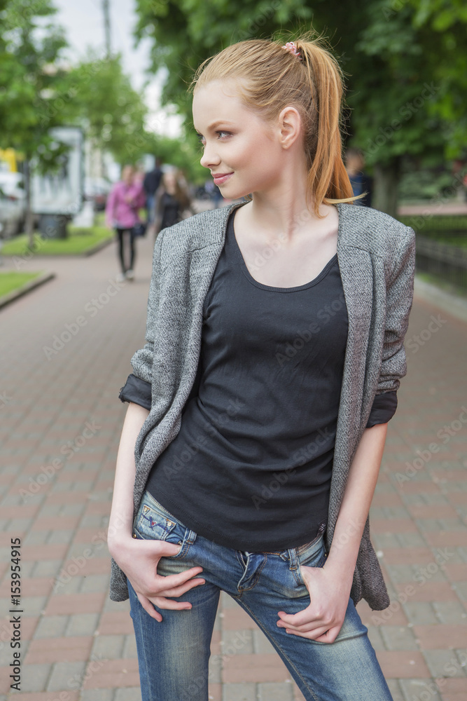 Beautiful red hair ginger slim young woman with fresh skin in casual outfit, posing. Sunny summer day in park (nature). Daylight Beautiful red hair ginger slim young woman with fresh skin in casual outfit, posing. Sunny summer day in park (nature). Daylight