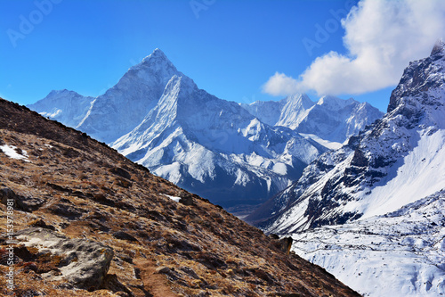 Majestic Ama Dablam Mountain on the background of blue sky, Nepal.