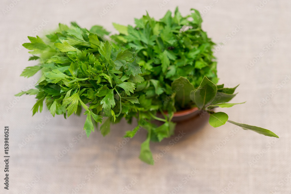 spicy greens in a pot on a background of a linen tablecloth spicy greens in a pot on a background of a linen tablecloth