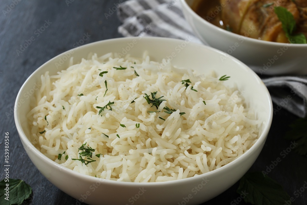 Cooked Long grain Basmati Rice served with chicken curry, selective focus Cooked Long grain Basmati Rice served with chicken curry, selective focus