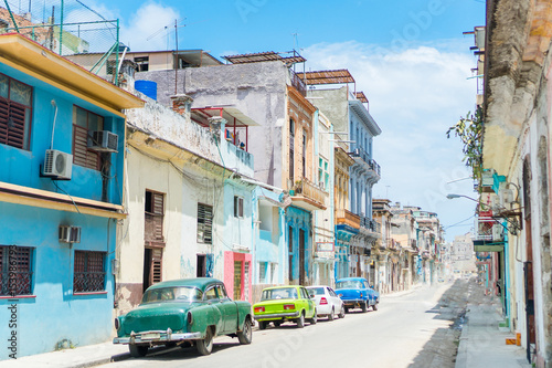 HAVANA, CUBA - APRIL 14, 2017: Authentic view of a street of Old Havana with old buildings and cars © travnikovstudio