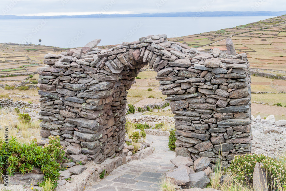 Stone arch on Pachatata hill on Amantani island in Titicaca lake, Peru Stone arch on Pachatata hill on Amantani island in Titicaca lake, Peru