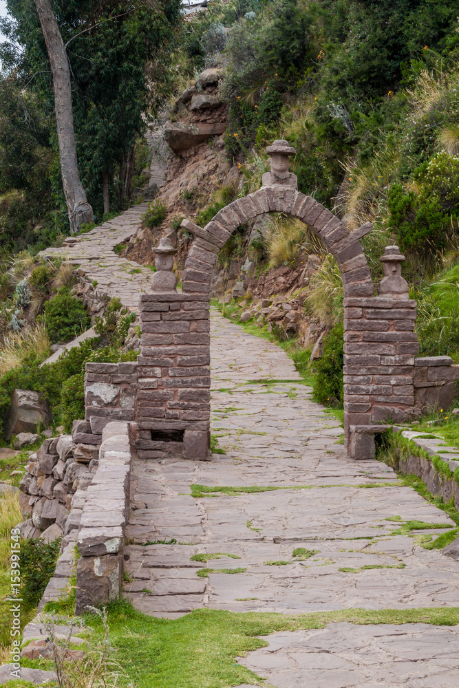 Path through a gate on Taquile island in Titicaca lake, Peru
