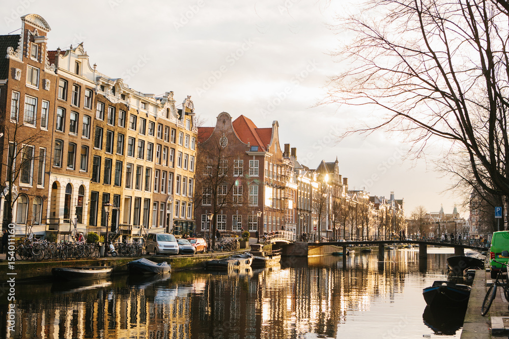 View of traditional houses in Amsterdam Netherlands Europe. Sunset. Evening. European style houses. Channels