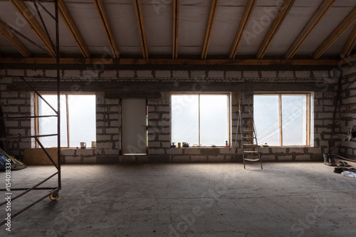 Interior of apartment with ladder during under renovation, remodeling and construction (preparing to plaster)