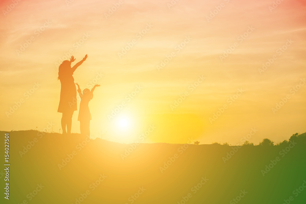 Mother encouraged her daughter out of the shadows at sunset. Mother encouraged her daughter out of the shadows at sunset.