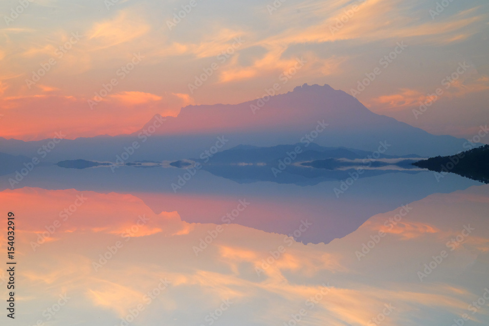 Beautiful reflection of Mount Kinabalu on peaceful river.