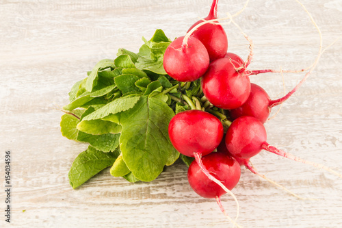 Radish on a white wooden background close up.