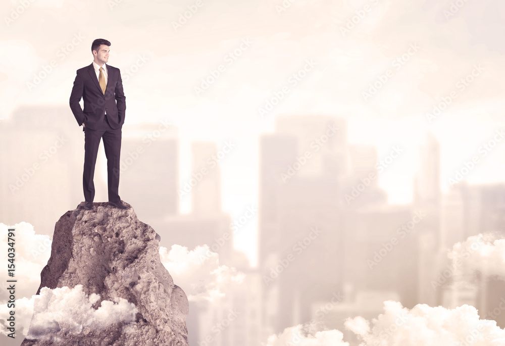 Confident businessman on dangerous cliff Confident businessman on dangerous cliff