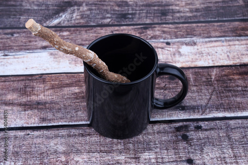 Traditional Natural Toothbrush Miswak or Siwak With Glass On Wooden Background.