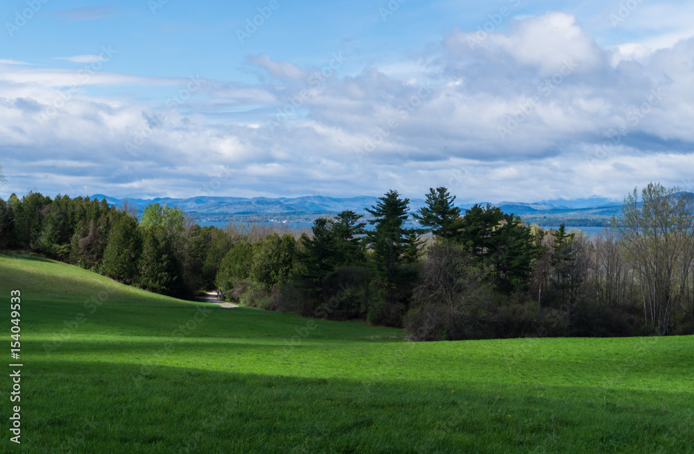 looking across farm field in shadows to Lake Champlain, Vermont , and beyond to mountains in New York state
looking across farm field in shadows to Lake Champlain, Vermont , and beyond to mountains in New York state