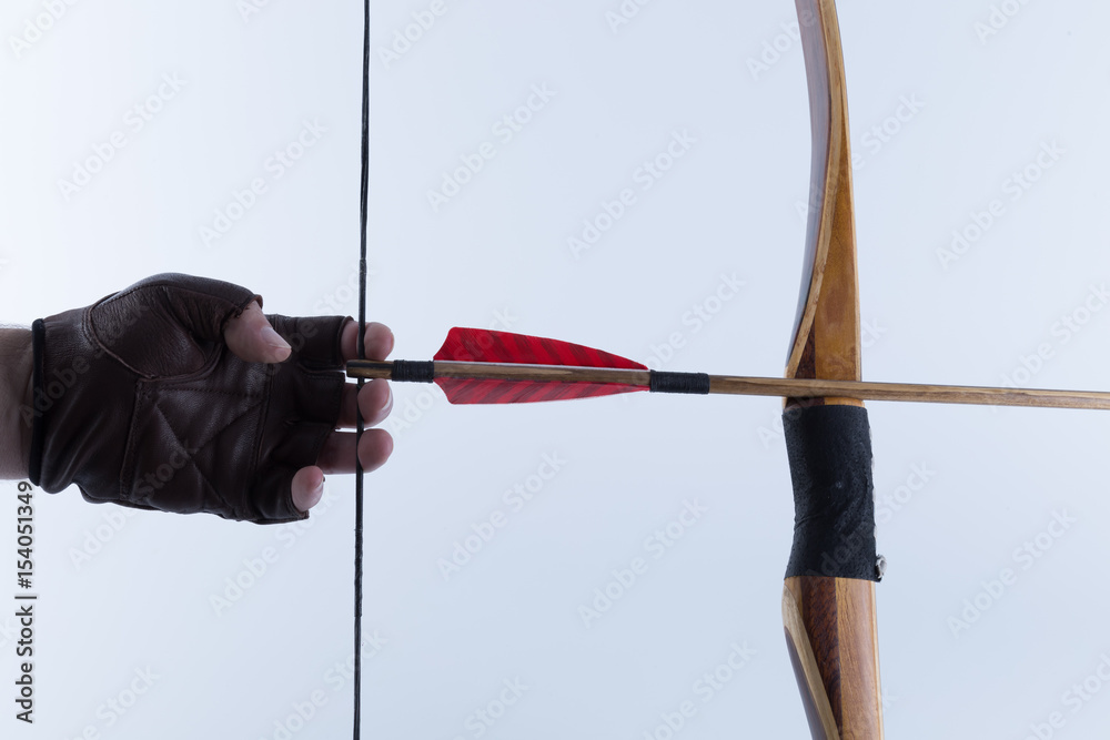 Archer wearing open fingers leather gloves drawing a traditional