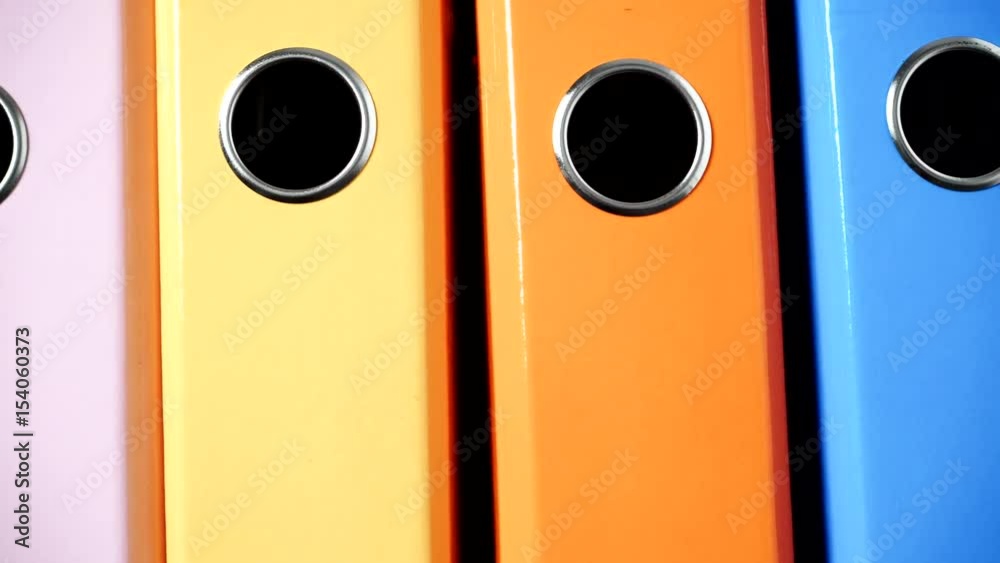 Close up of many colorful file folders, ring binders as vivid color office background. Dolly slider shot 4K ProRes HQ codec Close up of many colorful file folders, ring binders as vivid color office background. Dolly slider shot 4K ProRes HQ codec