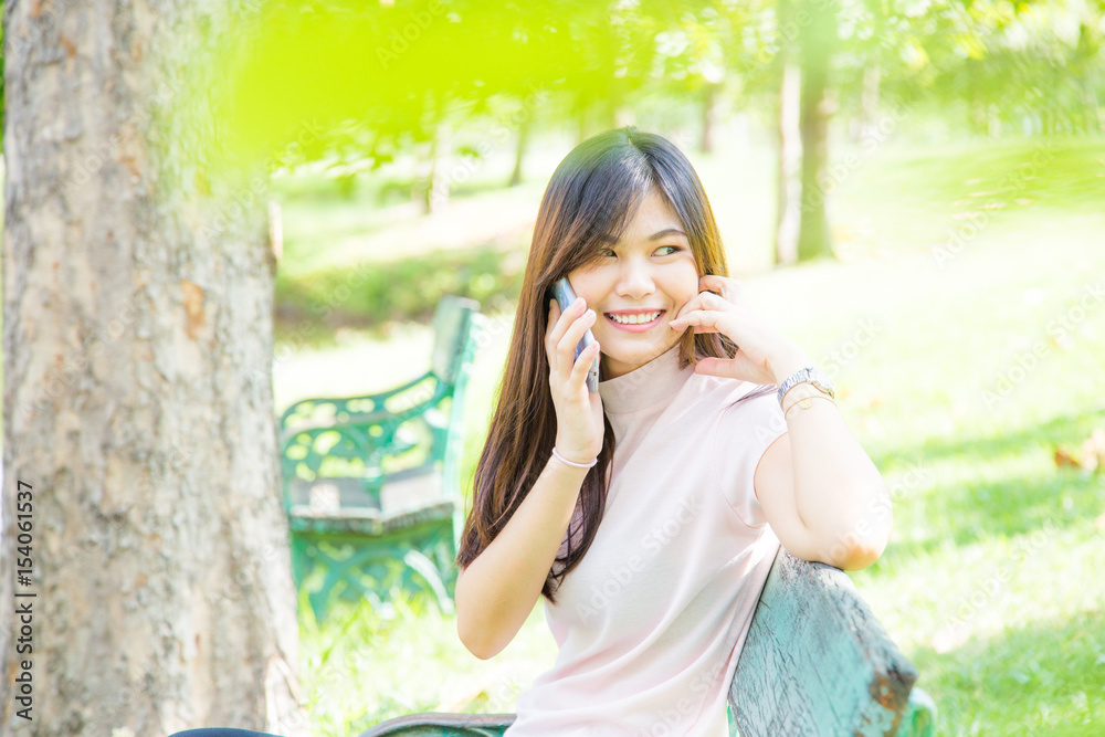 Beautiful asian woman using on the smart phone with feeling relax and smilng face Beautiful asian woman using on the smart phone with feeling relax and smilng face