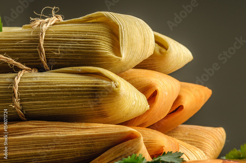 Mexican tamales made of corn and chicken isolated on white photo
