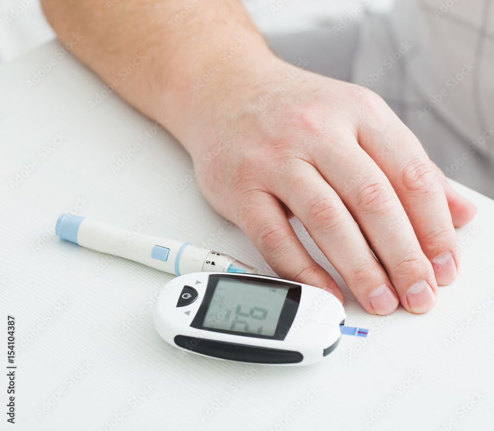 medicine, diabetes, glycemia, health care and people concept - close up of male finger with test stripe medicine, diabetes, glycemia, health care and people concept - close up of male finger with test stripe