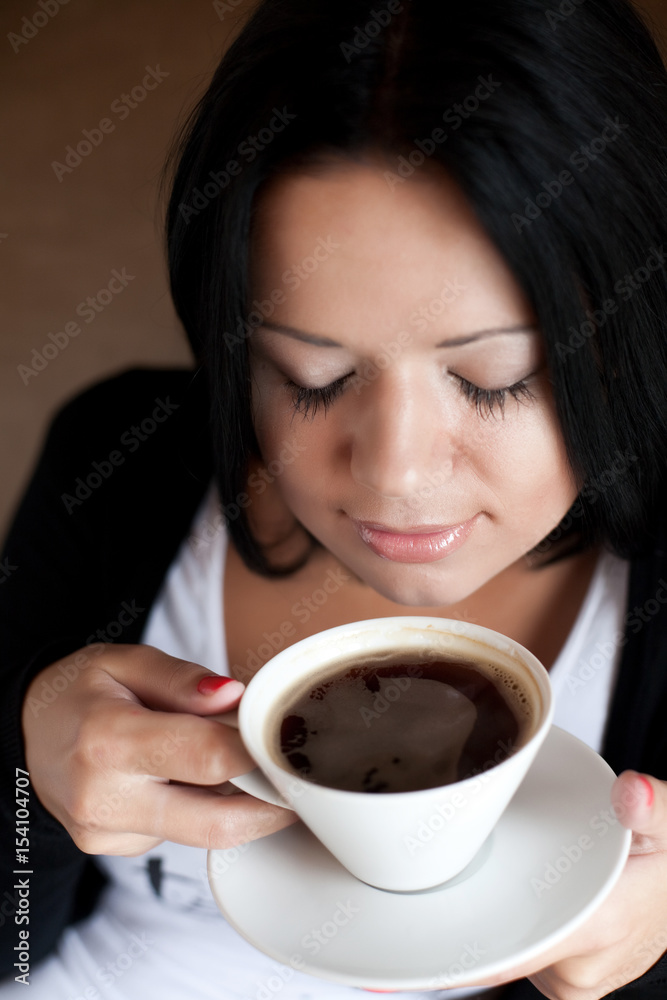 young woman sitting in a cafe drinking coffee young woman sitting in a cafe drinking coffee