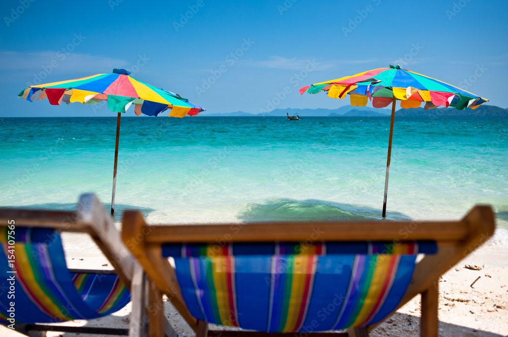 Beach chair under the umbrella of colorful on the beach Phuket, Thailand