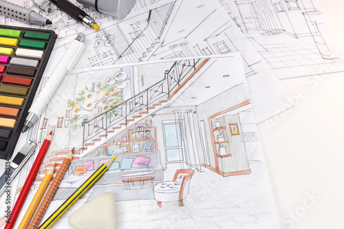 designers workplace with drawing tools and sketches of living room interior 