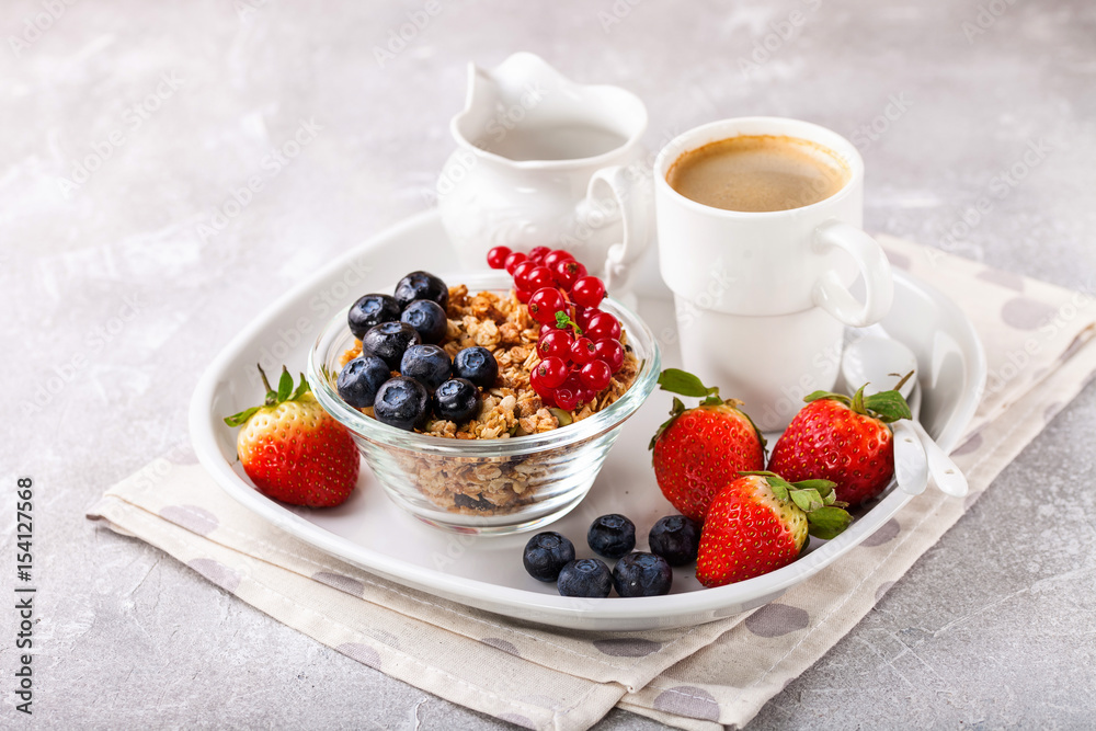 Breakfast - muesli, berries and coffee. Selective focus. Copy space Breakfast - muesli, berries and coffee. Selective focus. Copy space