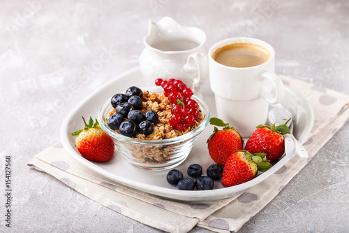 Breakfast - muesli, berries and coffee. Selective focus. Copy space