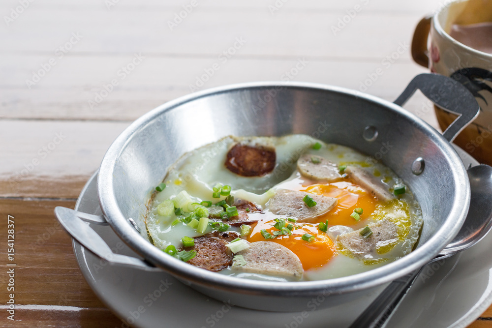 Fried eggs in a frying pan with sausage with pork mixed black pepper ,Breakfast, Healthy food.