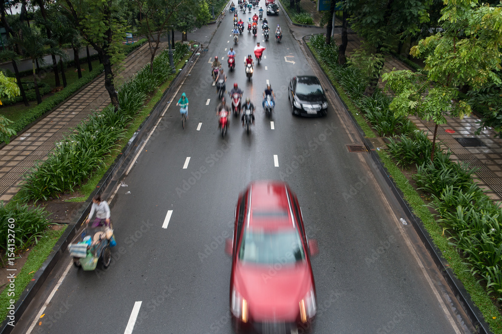 HO CHI MINH, VIETNAM - MAY 11 2017: Motorcycle traffic in rain. Is located in the South of Vietnam, is the country's largest city, population 8 million