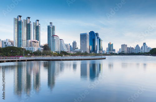 Twiligh tone  City office building with water reflection  in public park  Bangkok Thailand