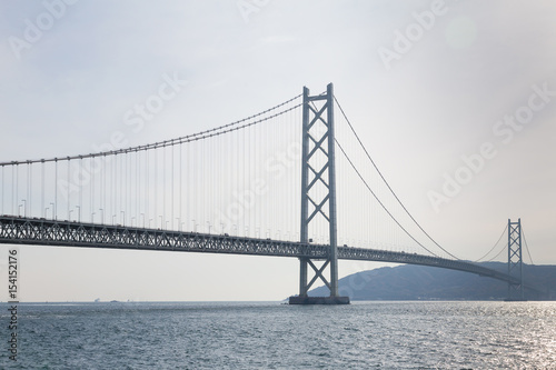 Long suspension bridge over ocean, Akashi Kaikyo Kobe Japan photo