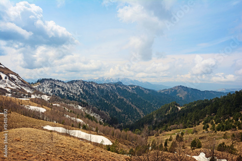 Springtime landscape of caucasus mountains with peaks covered by snow