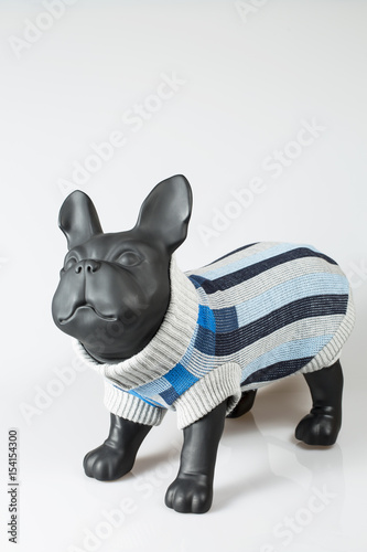 Plastic dog mannequin dressed with grey warm sweater