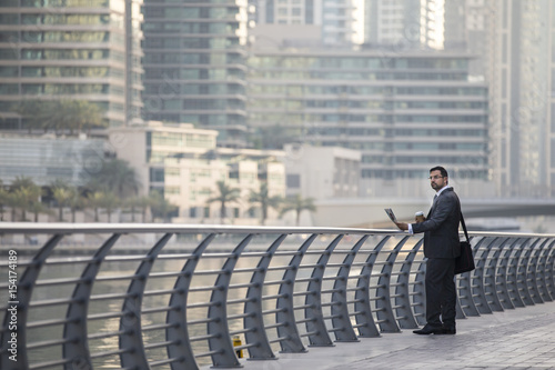 businessman reading a paper in Dubai Marina © katiekk2