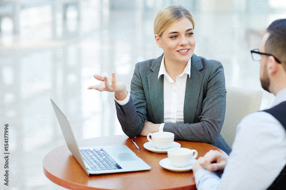 Businesswoman presenting financial information to her colleague Businesswoman presenting financial information to her colleague
