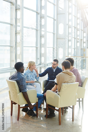 Team of modern business people communicating at meeting