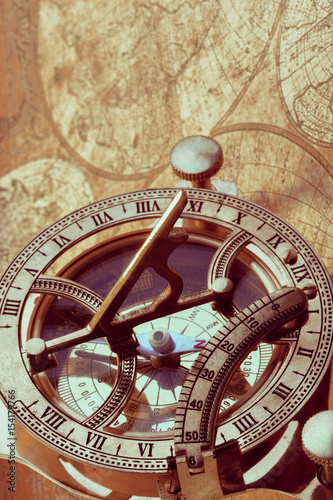 Old compass over ancient map