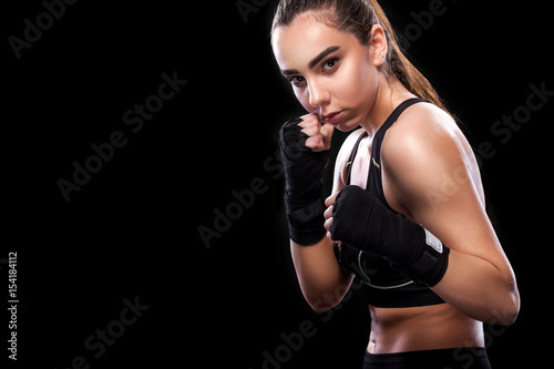 Sportsman muay thai boxer fighting. Isolated on black background. Copy Space.