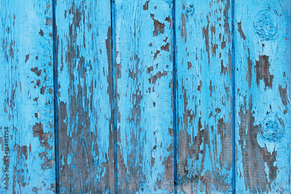 Old wooden fence with shabby paint use as background
