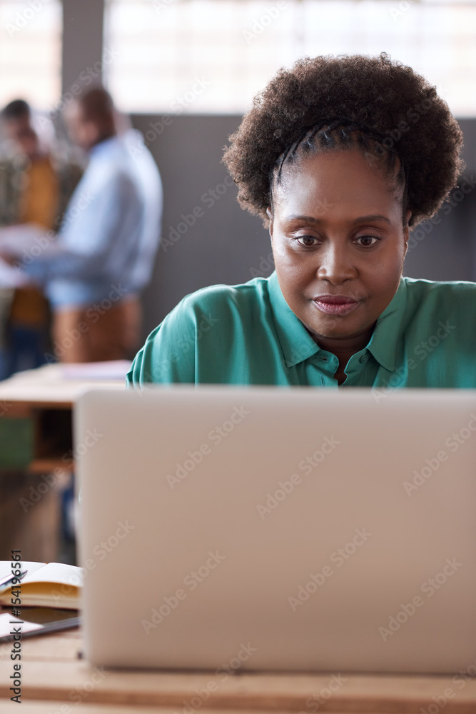 Young African businesswoman working on a laptop in an office Young African businesswoman working on a laptop in an office