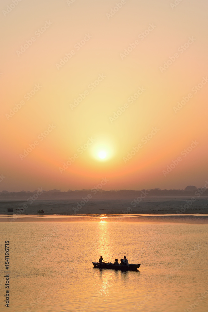 Tourists on wooden boats at Ganges river in Varanasi, India